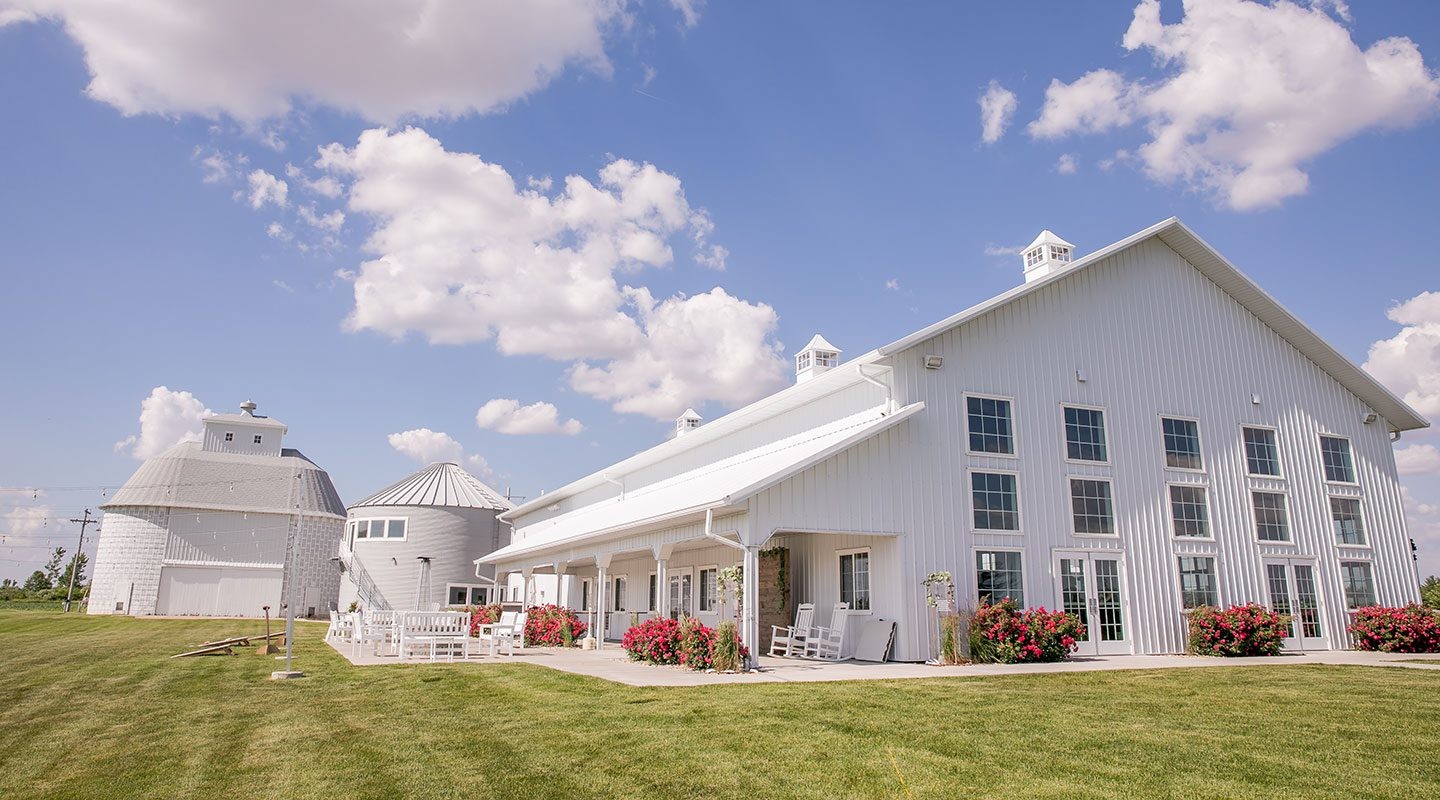 The white Barn at Fairview Acres beneath a bright country sky