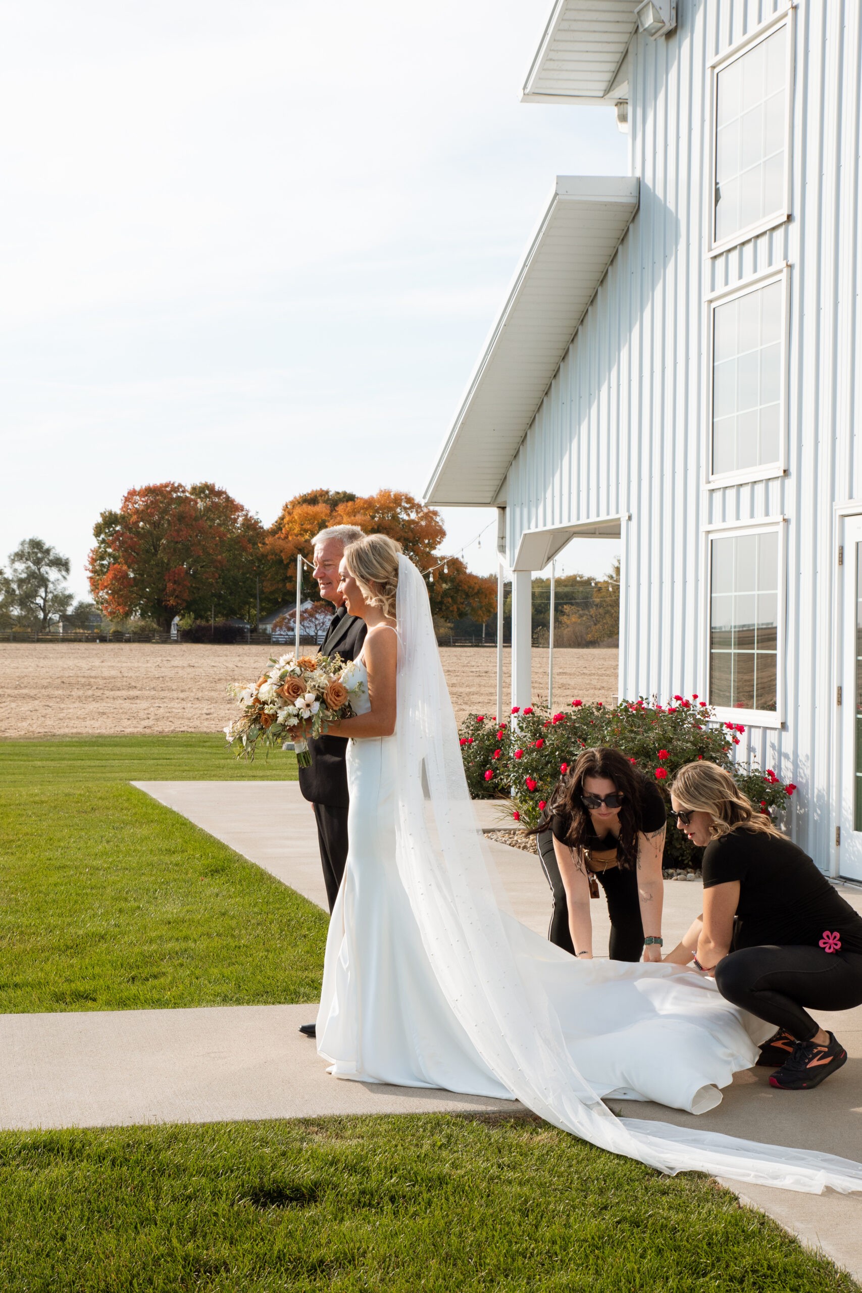 Bride outside the white barn