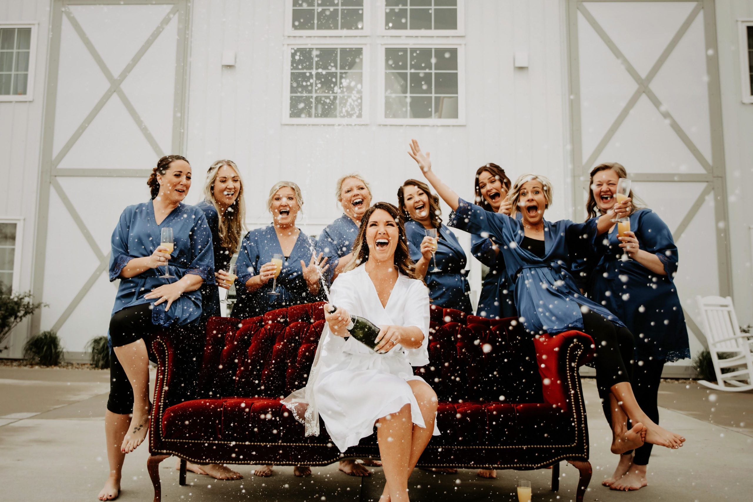 Wedding party celebrating outside the barn