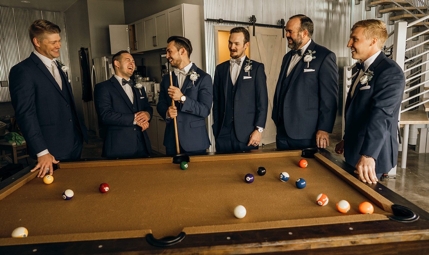 Groomsmen relaxing over a game of pool in the Grain Bin