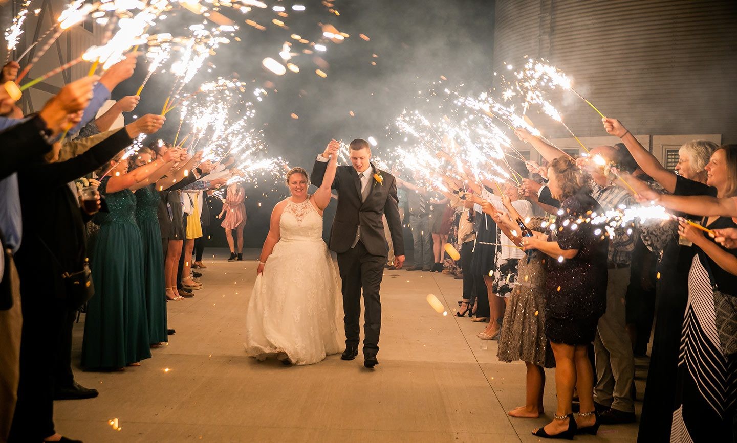 Newlyweds celebrating beneath sparklers